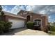 Charming home with a well-maintained lawn, large driveway, and a two-car garage at 513 Bailey Cir, Davenport, FL 33897