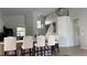 Open-concept kitchen with island seating, modern lighting, and a bright, airy feel at 513 Bailey Cir, Davenport, FL 33897