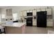 Spacious kitchen with stainless steel appliances, white cabinets, and a large island at 513 Bailey Cir, Davenport, FL 33897