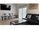 Cozy living area features a plush sofa, entertainment center, and natural light at 513 Bailey Cir, Davenport, FL 33897