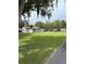 Large backyard with mature trees providing ample shade and green grass at 524 Florida Ave, St Cloud, FL 34769