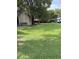 Spacious backyard with lush green grass and mature trees at 524 Florida Ave, St Cloud, FL 34769