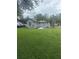 Exterior shot of the house featuring a spacious backyard at 524 Florida Ave, St Cloud, FL 34769