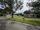 Street view of home featuring a well-manicured lawn and mature trees providing shade at 524 Florida Ave, St Cloud, FL 34769