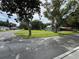 Street view featuring a home with a spacious front lawn and mature trees on a corner lot at 524 Florida Ave, St Cloud, FL 34769