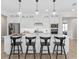 Bright kitchen with a large island, stainless steel appliances and modern lighting fixtures at 5242 Handsome Hills Dr, Mount Dora, FL 32757