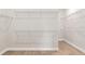 Spacious walk-in closet features wire shelving and wood-look tile flooring at 5242 Handsome Hills Dr, Mount Dora, FL 32757