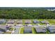 Aerial view of several homes and neighborhood streets surrounded by lush greenery at 5264 Obsidian Gate Dr, Mount Dora, FL 32757