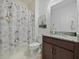 Charming bathroom with a Paris-themed shower curtain, vanity, and ample storage at 5264 Obsidian Gate Dr, Mount Dora, FL 32757