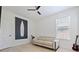Neutral bedroom features wood floors, ceiling fan, and a comfortable loveseat at 5264 Obsidian Gate Dr, Mount Dora, FL 32757