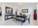 Dining room features an oversized painting, a dark table with seating and marble floors at 5264 Obsidian Gate Dr, Mount Dora, FL 32757