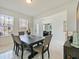 Bright dining room featuring a modern table set, tile flooring, and views to the entryway and office at 5264 Obsidian Gate Dr, Mount Dora, FL 32757