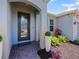 A decorative front door with sidelights and manicured landscaping at 5264 Obsidian Gate Dr, Mount Dora, FL 32757