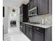 Well appointed kitchen with granite countertops, stainless steel appliances, and dark wood cabinetry at 5264 Obsidian Gate Dr, Mount Dora, FL 32757
