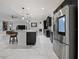 Modern kitchen with stainless steel appliances, dark cabinetry, and a center island, seamlessly connected to the living area at 5264 Obsidian Gate Dr, Mount Dora, FL 32757