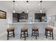 Gourmet kitchen island with seating features granite counters, pendant lighting, and dark wood cabinetry at 5264 Obsidian Gate Dr, Mount Dora, FL 32757