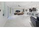 Expansive living room features sleek tile flooring, modern furniture, and an open-concept design at 5264 Obsidian Gate Dr, Mount Dora, FL 32757