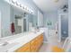 Well-lit bathroom featuring a dual sink vanity, a walk-in shower, and a soaking tub at 5353 Red Leaf Ct, Oviedo, FL 32765