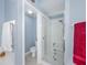 A bathroom with a walk-in shower that has a built in seat and safety bar at 5353 Red Leaf Ct, Oviedo, FL 32765