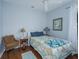 Comfortable bedroom with hardwood floors, soft lighting, and a patterned comforter on the bed at 5353 Red Leaf Ct, Oviedo, FL 32765