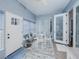Bright Florida room with white furnishings, a round glass top table, and multiple windows at 5353 Red Leaf Ct, Oviedo, FL 32765