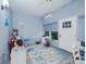 Light and airy Florida room with blue shiplap walls, ceiling fan, and comfortable seating at 5353 Red Leaf Ct, Oviedo, FL 32765