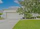 Lovely home with a two-car garage, well-kept lawn, and neatly trimmed hedges at 5353 Red Leaf Ct, Oviedo, FL 32765