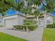 Charming single-story home with a manicured lawn, decorative flowerbeds, and an attached garage at 5353 Red Leaf Ct, Oviedo, FL 32765