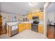 A view of a kitchen with stainless appliances and light colored cabinetry at 5353 Red Leaf Ct, Oviedo, FL 32765