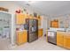 Bright kitchen featuring stainless steel appliances, light wood cabinets, and tiled flooring at 5353 Red Leaf Ct, Oviedo, FL 32765