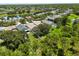 Gorgeous aerial view of a beautiful home and community with mature trees and a serene lake view at 5451 Los Palma Vista Dr, Orlando, FL 32837