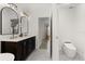 Modern bathroom featuring double sink vanity, luxury toilet, and herringbone pattern floors at 5451 Los Palma Vista Dr, Orlando, FL 32837