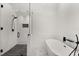 Modern bathroom with glass-enclosed shower and sleek soaking tub at 5451 Los Palma Vista Dr, Orlando, FL 32837