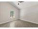 Bright bedroom featuring vaulted ceilings, neutral walls, and herringbone-patterned tile flooring at 5451 Los Palma Vista Dr, Orlando, FL 32837