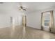 Spacious bedroom with tile floors in herringbone pattern, ceiling fan, and natural light at 5451 Los Palma Vista Dr, Orlando, FL 32837