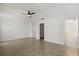 Bright bedroom with ceiling fan, tile floors in herringbone pattern, and ensuite bathroom at 5451 Los Palma Vista Dr, Orlando, FL 32837