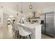 Bright kitchen features white cabinetry, a quartz island countertop, stainless appliances, and herringbone floors at 5451 Los Palma Vista Dr, Orlando, FL 32837
