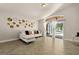 Bright living room with herringbone floors and access to a screened patio through sliding glass doors at 5451 Los Palma Vista Dr, Orlando, FL 32837