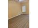 A bedroom with wood floors and a window with blinds at 5821 La Costa Dr # 108, Orlando, FL 32807