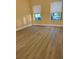 Bedroom with new flooring, fresh paint, and windows offering views of the outdoors at 5821 La Costa Dr # 108, Orlando, FL 32807