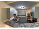 A modern kitchen with granite countertops, new stainless steel appliances, and grey cabinets at 5821 La Costa Dr # 108, Orlando, FL 32807