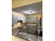 A modern kitchen with granite countertops, new stainless steel appliances, and grey cabinets at 5821 La Costa Dr # 108, Orlando, FL 32807