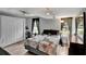 Cozy bedroom with wood-look floors, ample natural light, and a ceiling fan for added comfort at 601 Swallow Ct, Apopka, FL 32712