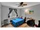 Cozy bedroom features a large window for natural light, a ceiling fan, and wood-look floors at 601 Swallow Ct, Apopka, FL 32712