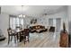 Open-concept living room with a dining area, bathed in natural light, creating an inviting atmosphere at 601 Swallow Ct, Apopka, FL 32712