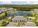 Aerial view of a community with clubhouse, pool, pond and wooded area at 6566 S Goldenrod Rd # 82A, Orlando, FL 32822