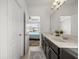 Bathroom featuring a double vanity and access to the bedroom at 6566 S Goldenrod Rd # 82A, Orlando, FL 32822