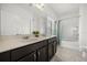 Bathroom featuring a double vanity with granite countertops and a shower-tub combo at 6566 S Goldenrod Rd # 82A, Orlando, FL 32822