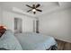 Spacious bedroom with wood-look floors, ceiling fan, and en-suite bathroom access at 6566 S Goldenrod Rd # 82A, Orlando, FL 32822