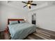 Bright bedroom featuring a ceiling fan, wood floors, and an ensuite bathroom at 6566 S Goldenrod Rd # 82A, Orlando, FL 32822